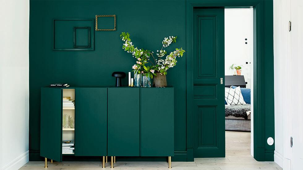 Emerald green console table and feature wall