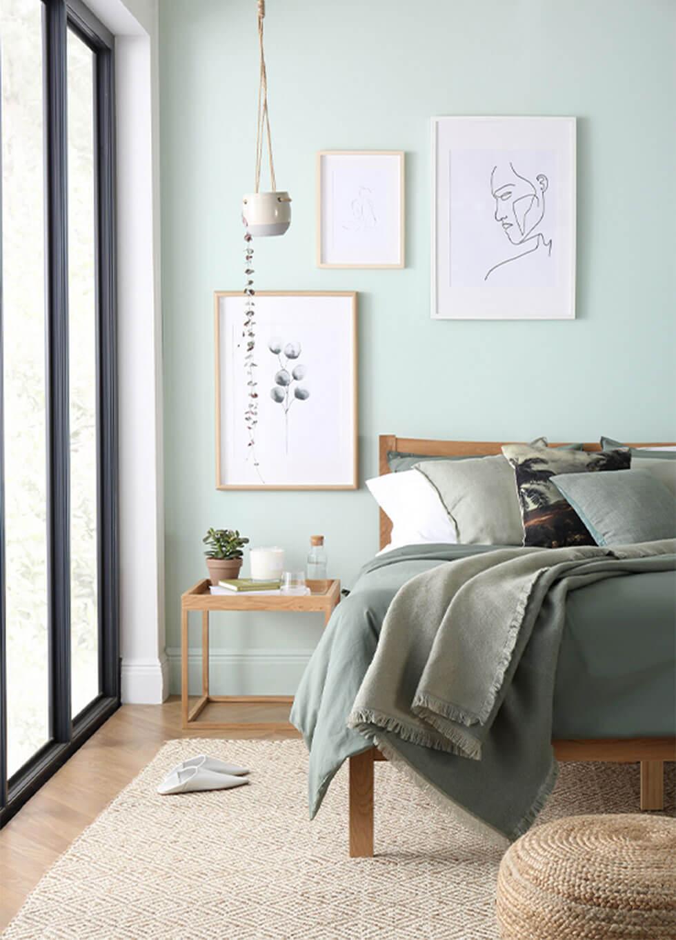 Sage green walls in a calm serene bedroom