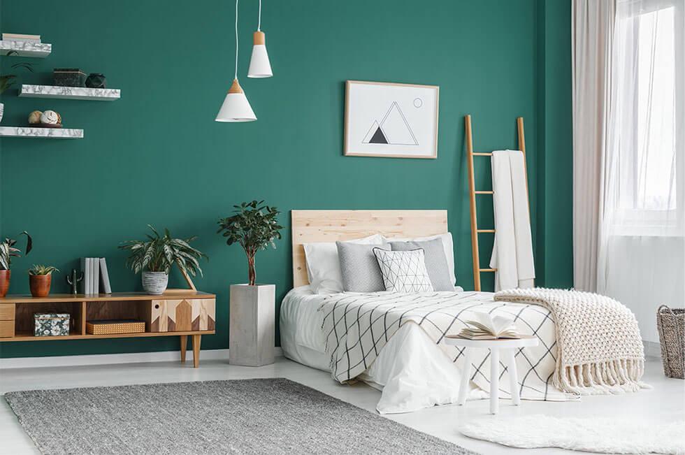 Scandinavian style bedroom with a green wall