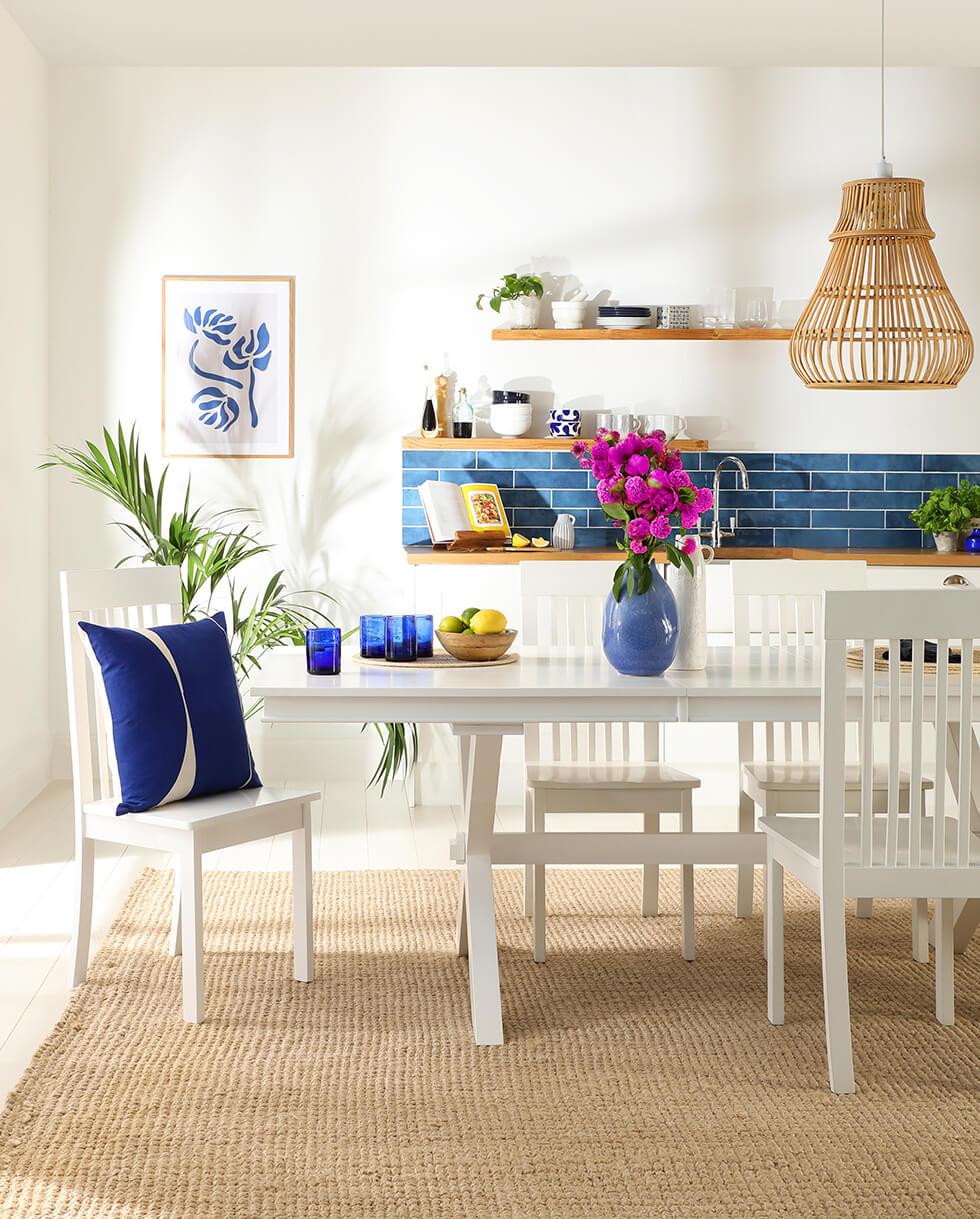 Greece-inspired dining room with a fresh white wooden dining set.