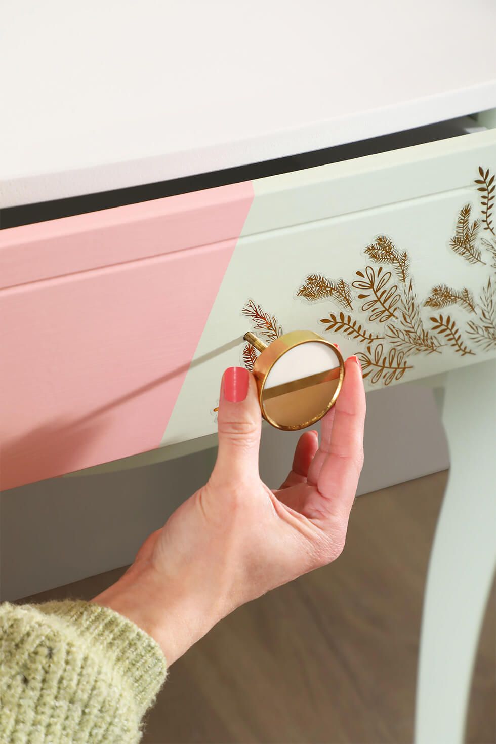 Attach the brass door handle to the drawer