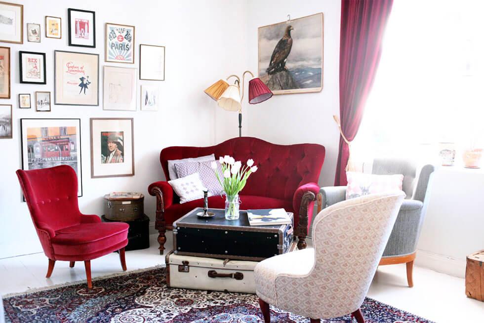 Statement red velvet sofa and armchair in a modern white living room