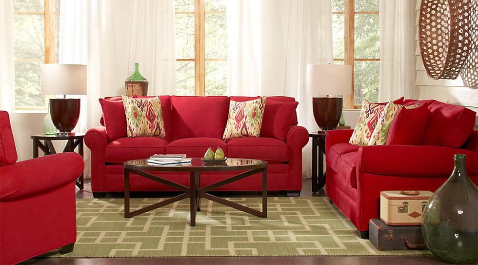 Red sofa suite with green rug and woven basket decor