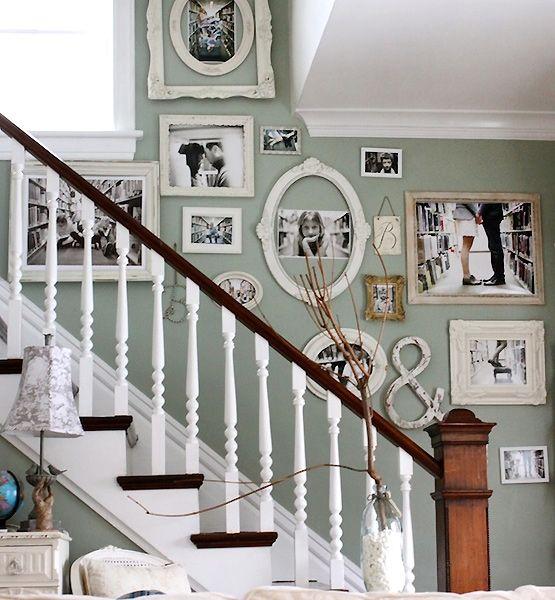 White vintage-inspired stairs with framed photographs. 
