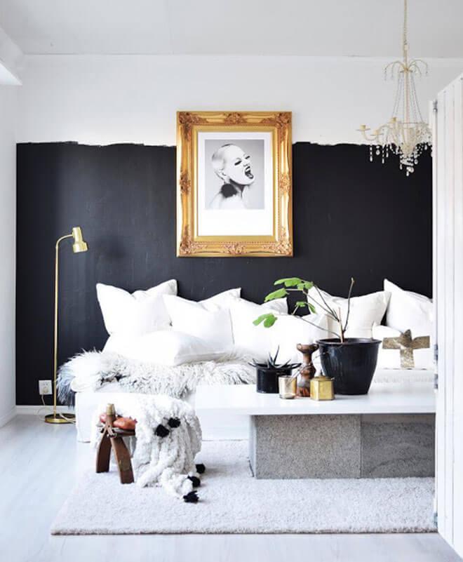 Bold black and white living space with gold frame.