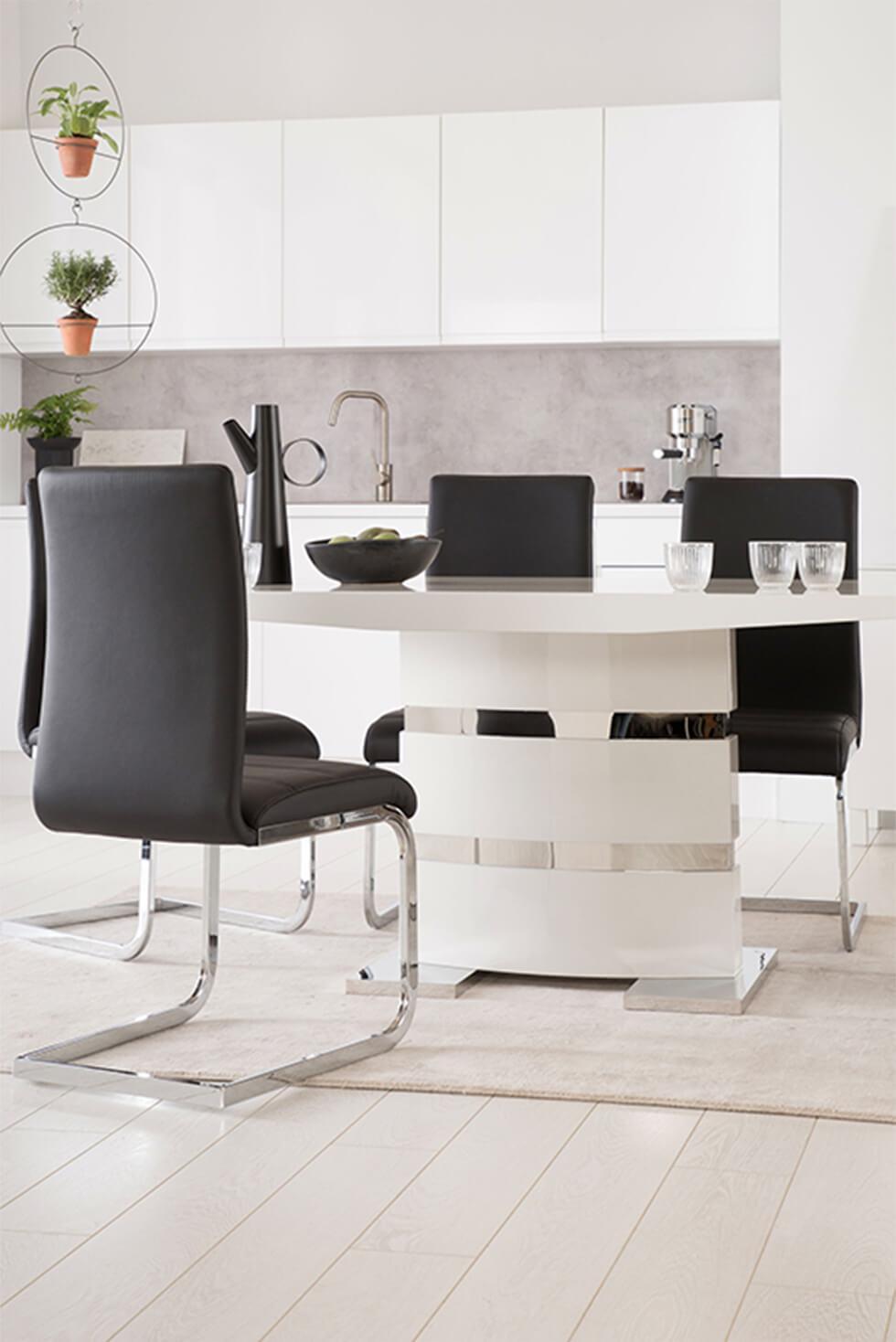 Modern living room with white high gloss table and black leather chairs with chrome legs