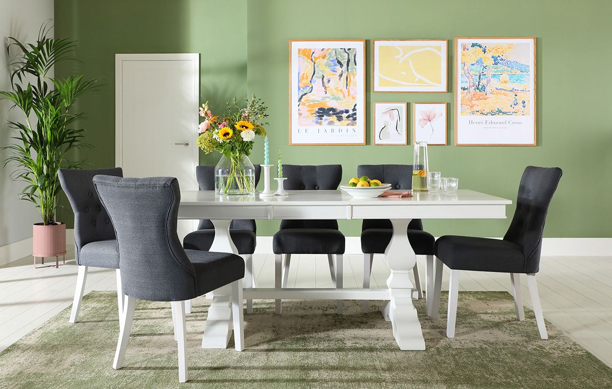 Green pastel dining room with white dining set and floral hues