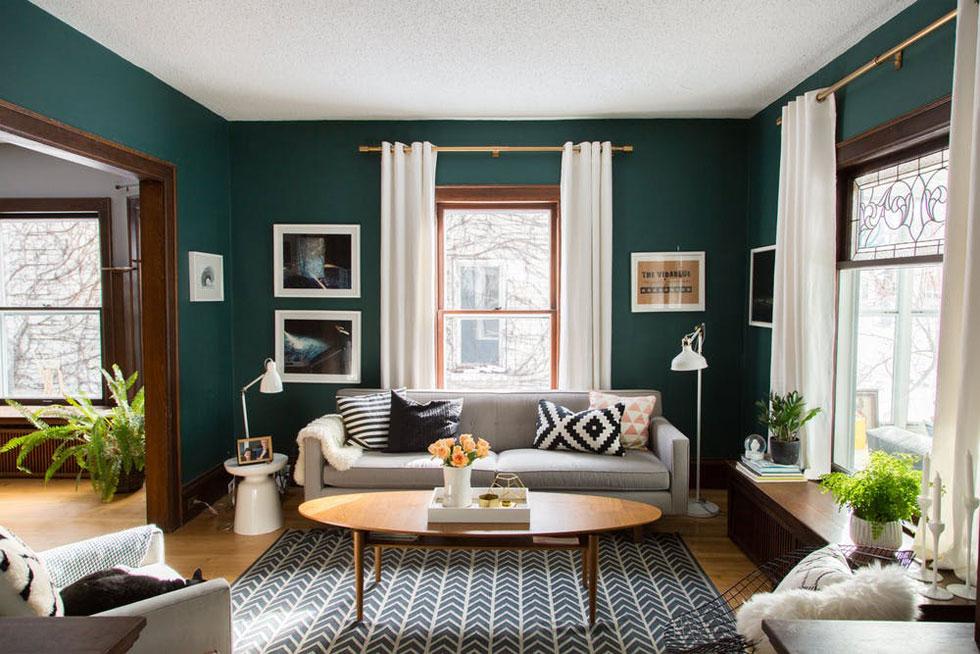 Living room with dark green walls and wooden furniture