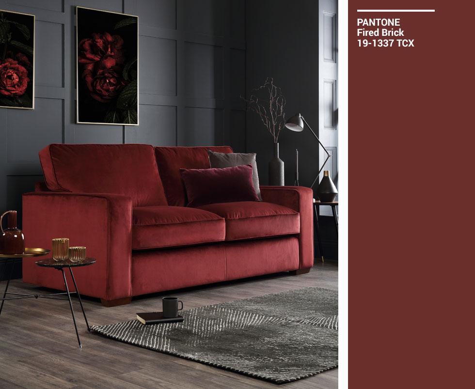 Deep red sofa in a dark grey living room, with a Pantone swatch.