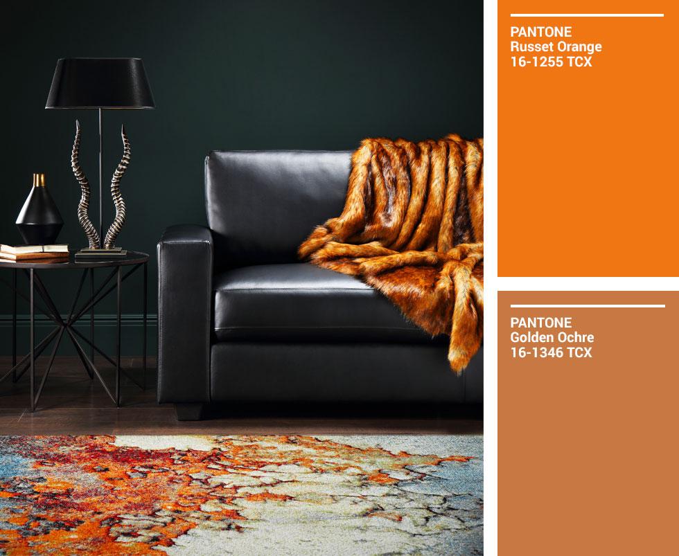 Black leather sofa accented with an ochre fur throw, with matching Pantone swatches.