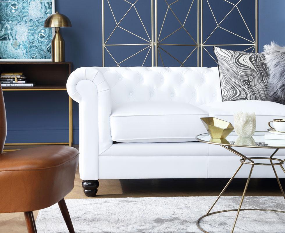 White sofa in a living room accented with gold decorations.