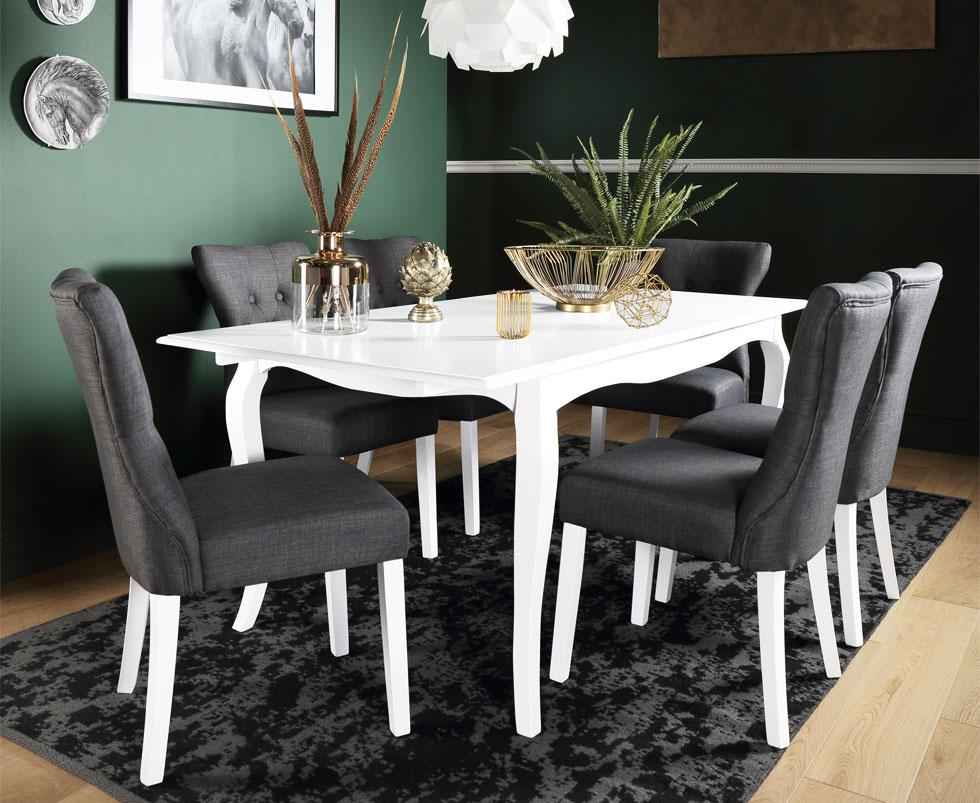 White and grey dining set in a dark green room.