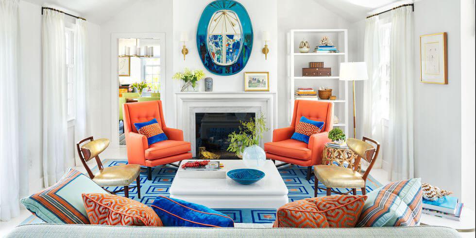 An airy living space with bright coral and blue elements.