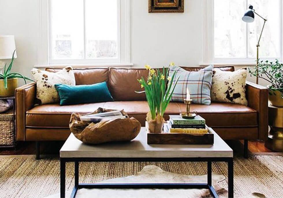 A brown sofa in a neutral space.