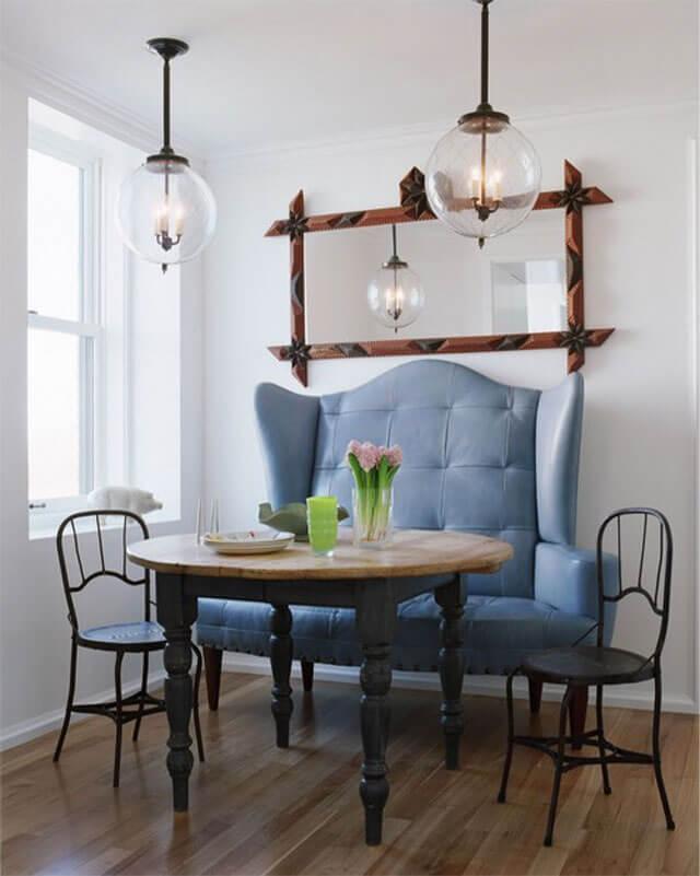 Breakfast nook with a sofa and a wooden table with dark legs.