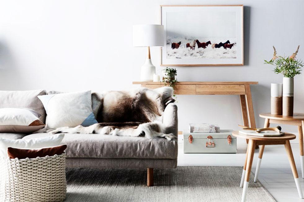 A living room in neutral tones with a fur throw