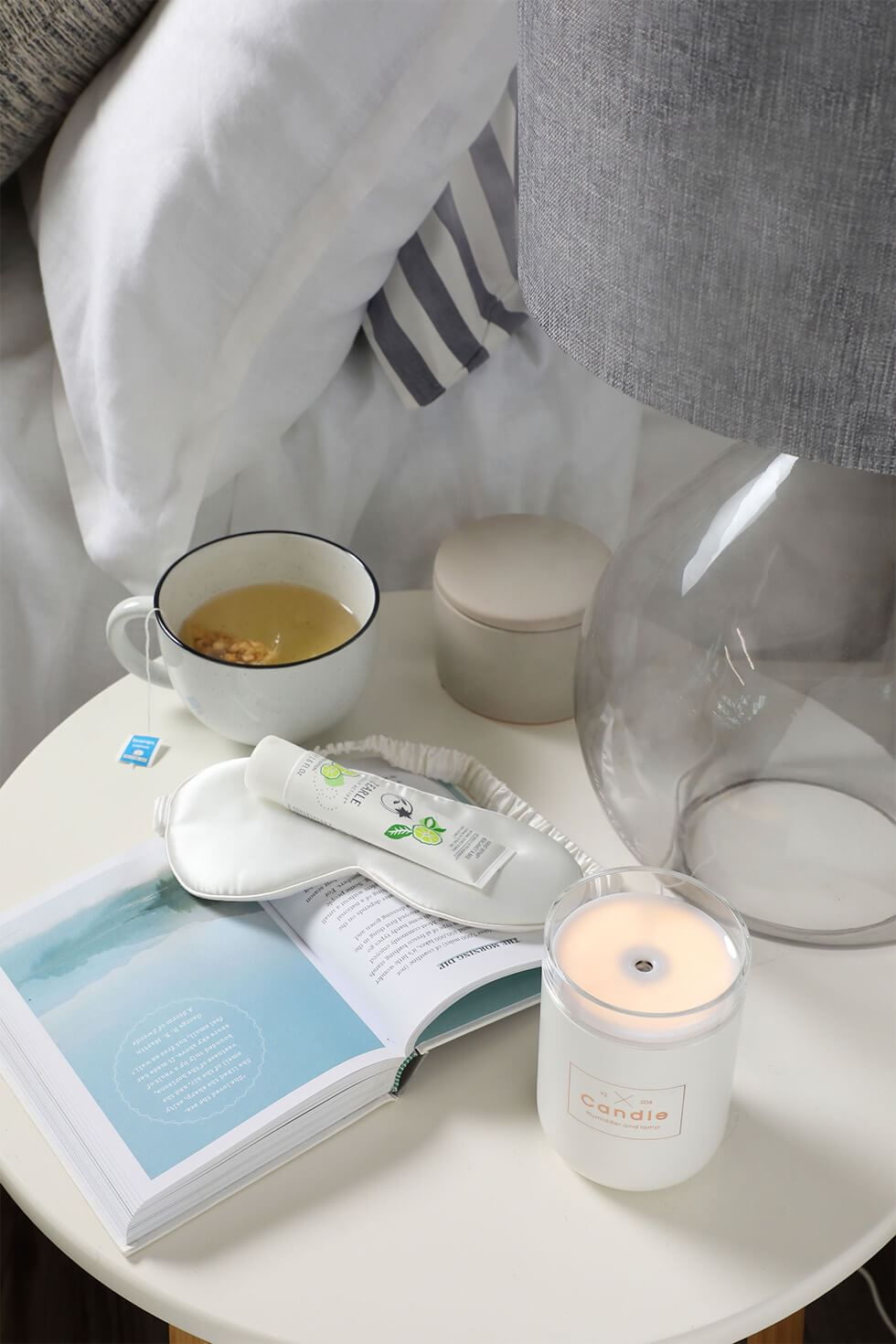 Relaxing scented candles and diffusers on bedside table