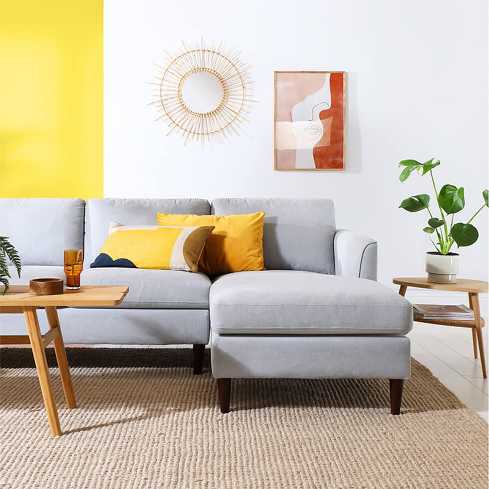 Grey sofa in yellow and white colour blocked living room