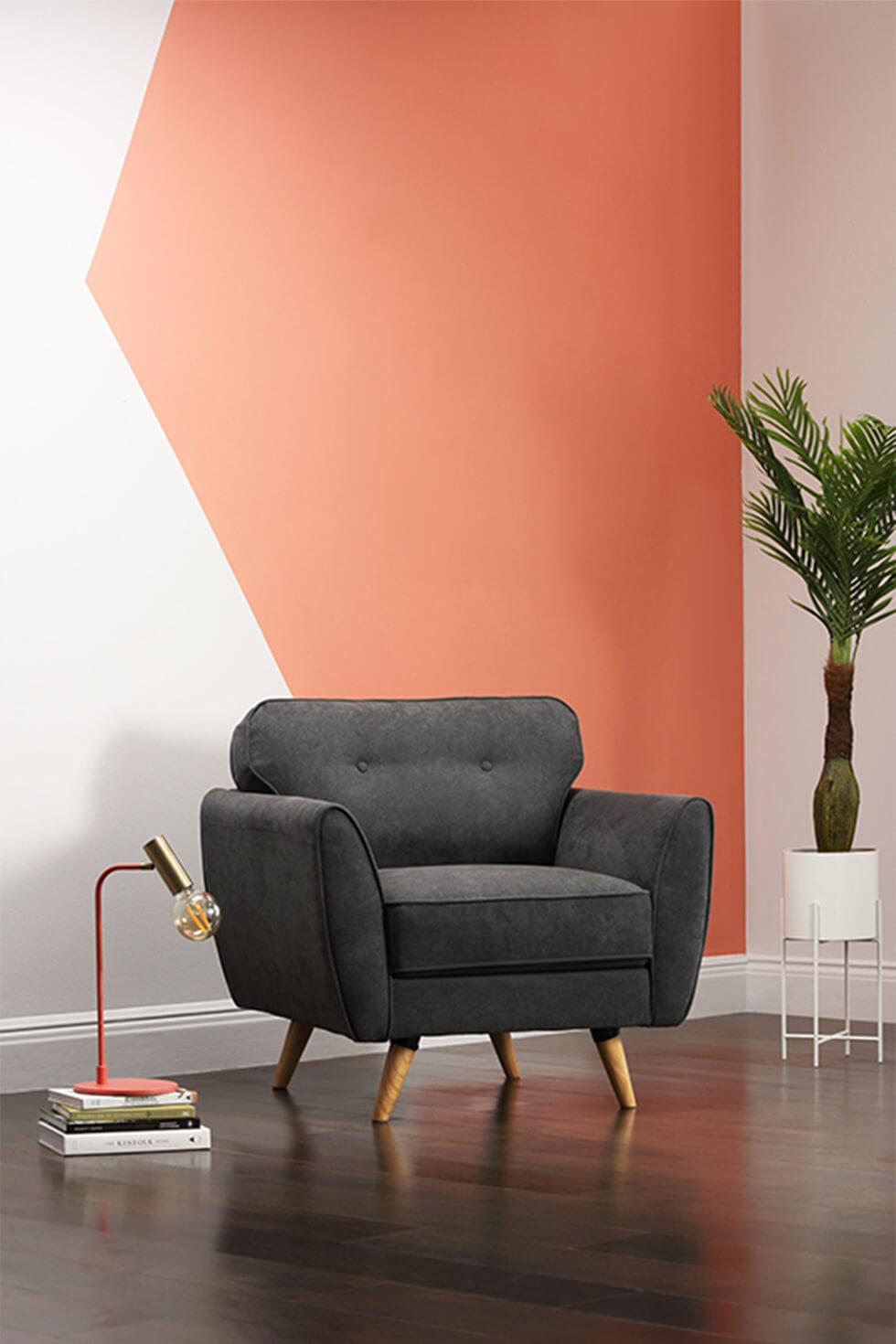 Coral colour blocked wall with grey armchair