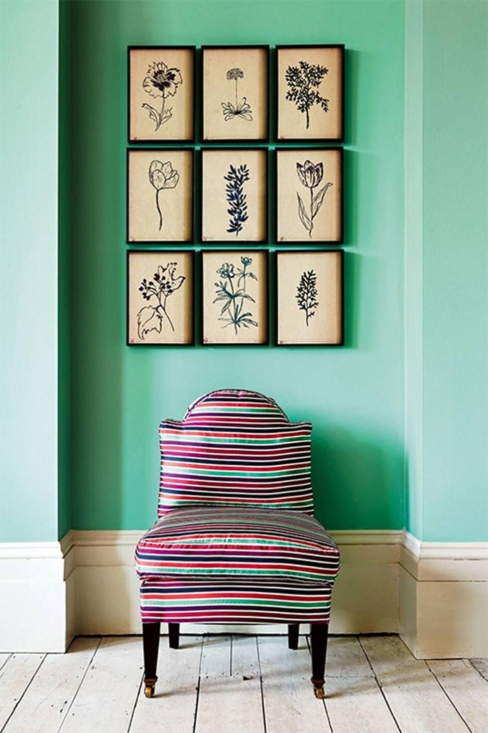 Green pastel living room with colourful armchair