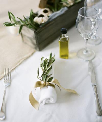 Table setting with leaves and linen.
