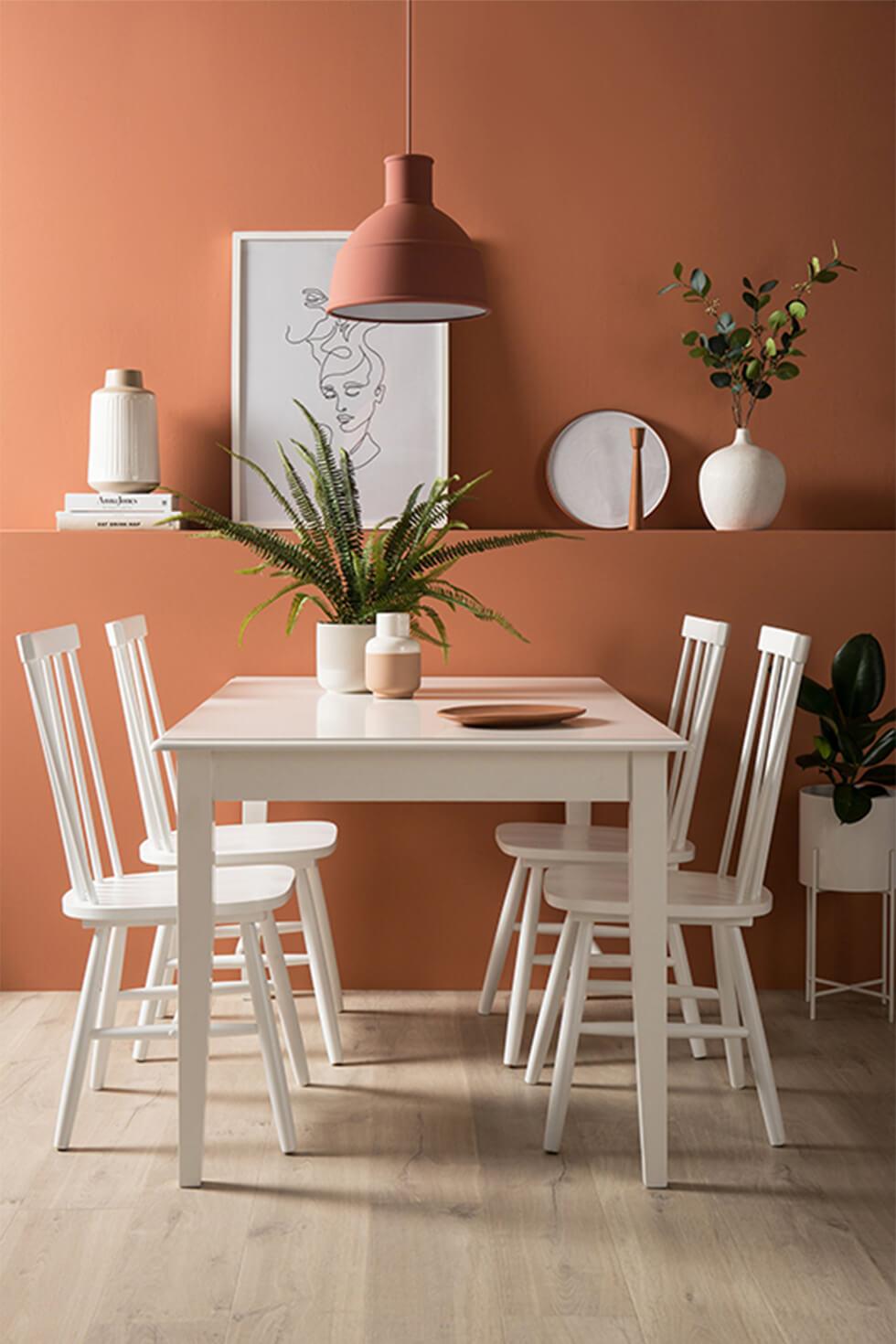 Orange dining room with white dining set