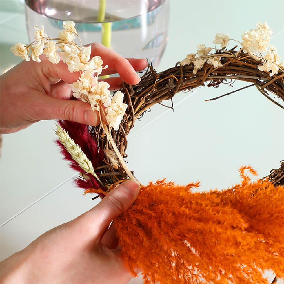 Step 3 - Fill in the rattan hoop with smaller flowers, using florist wire to secure if necessary