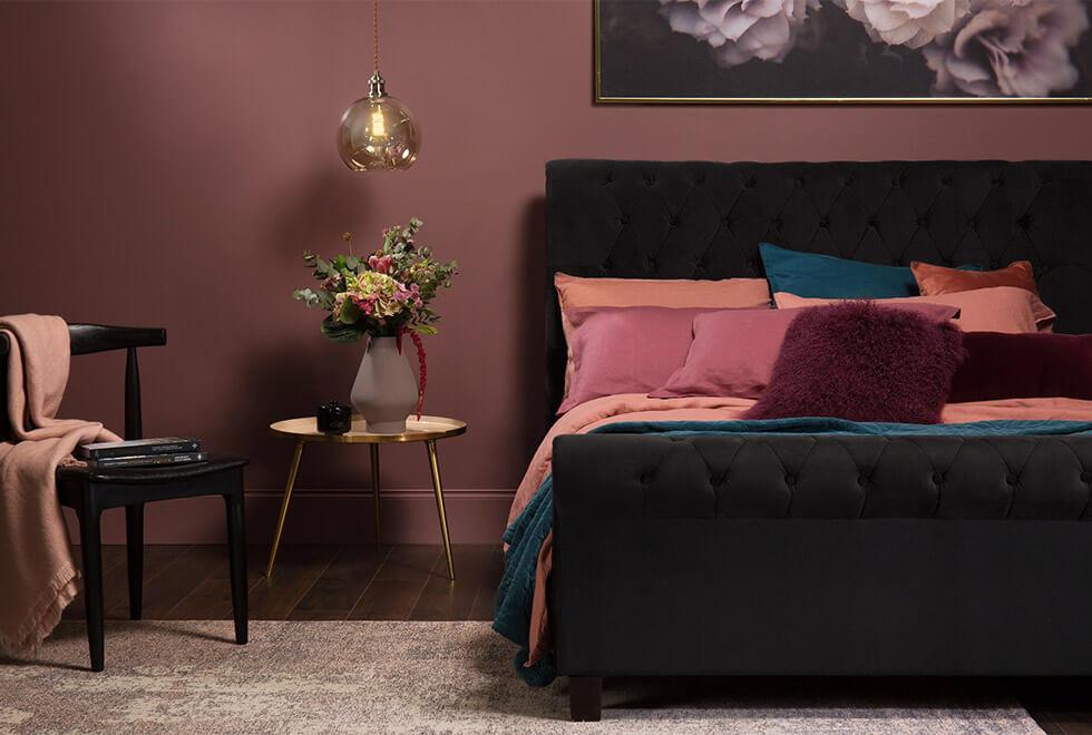 black velvet bed in a jewel toned bedroom