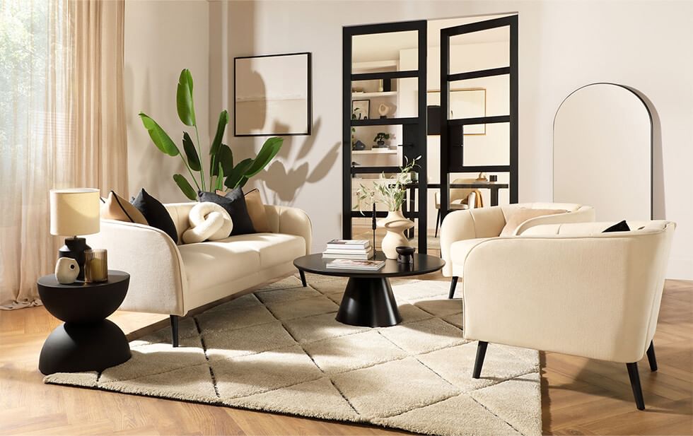 Stylish sofa and armchairs in a feng shui living room layout