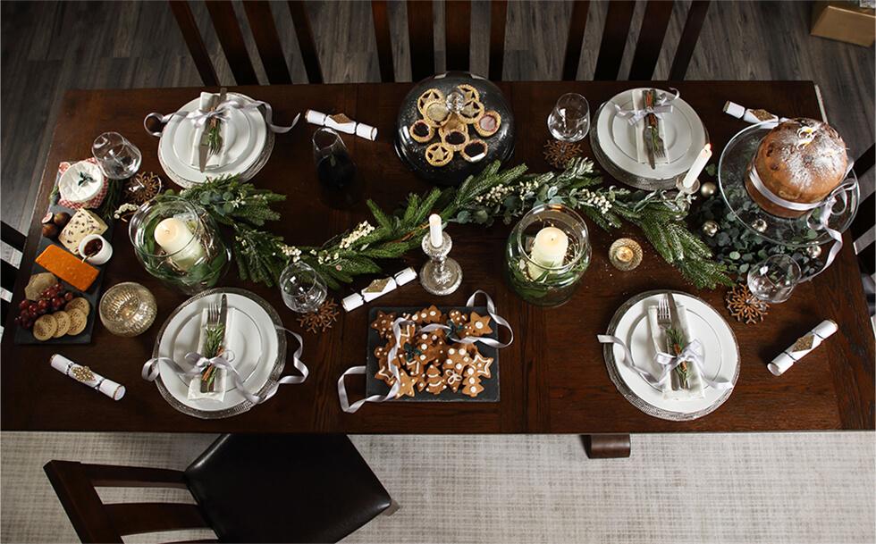 Christmas dinner table setting with candles and decorations