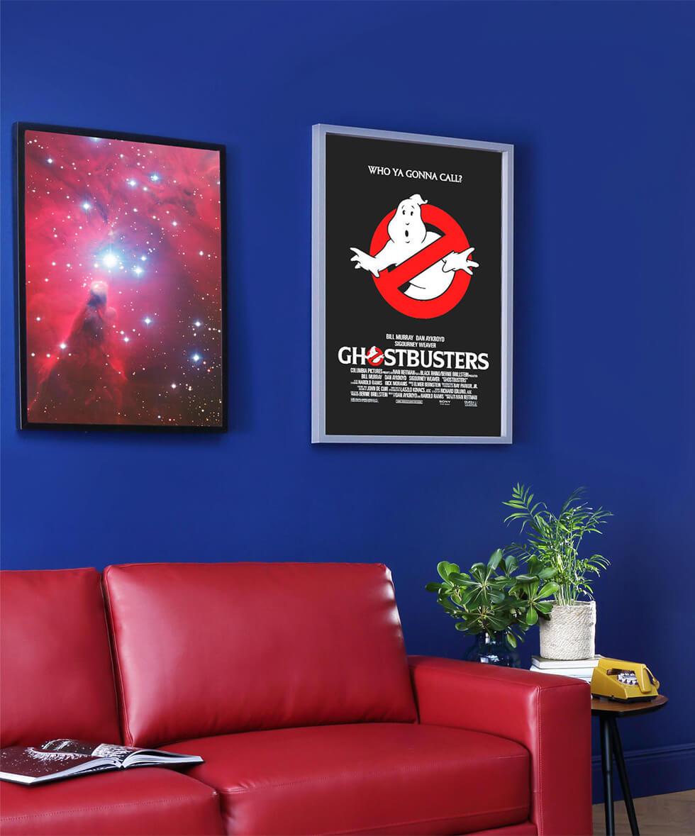 Stranger things inspired living room with blue walls, red leather sofa and Ghostbusters poster