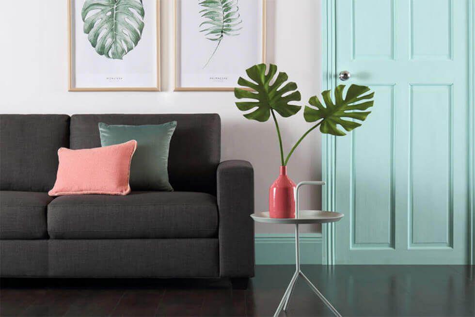 Living room with tropical pops of colour and slate grey sofa 