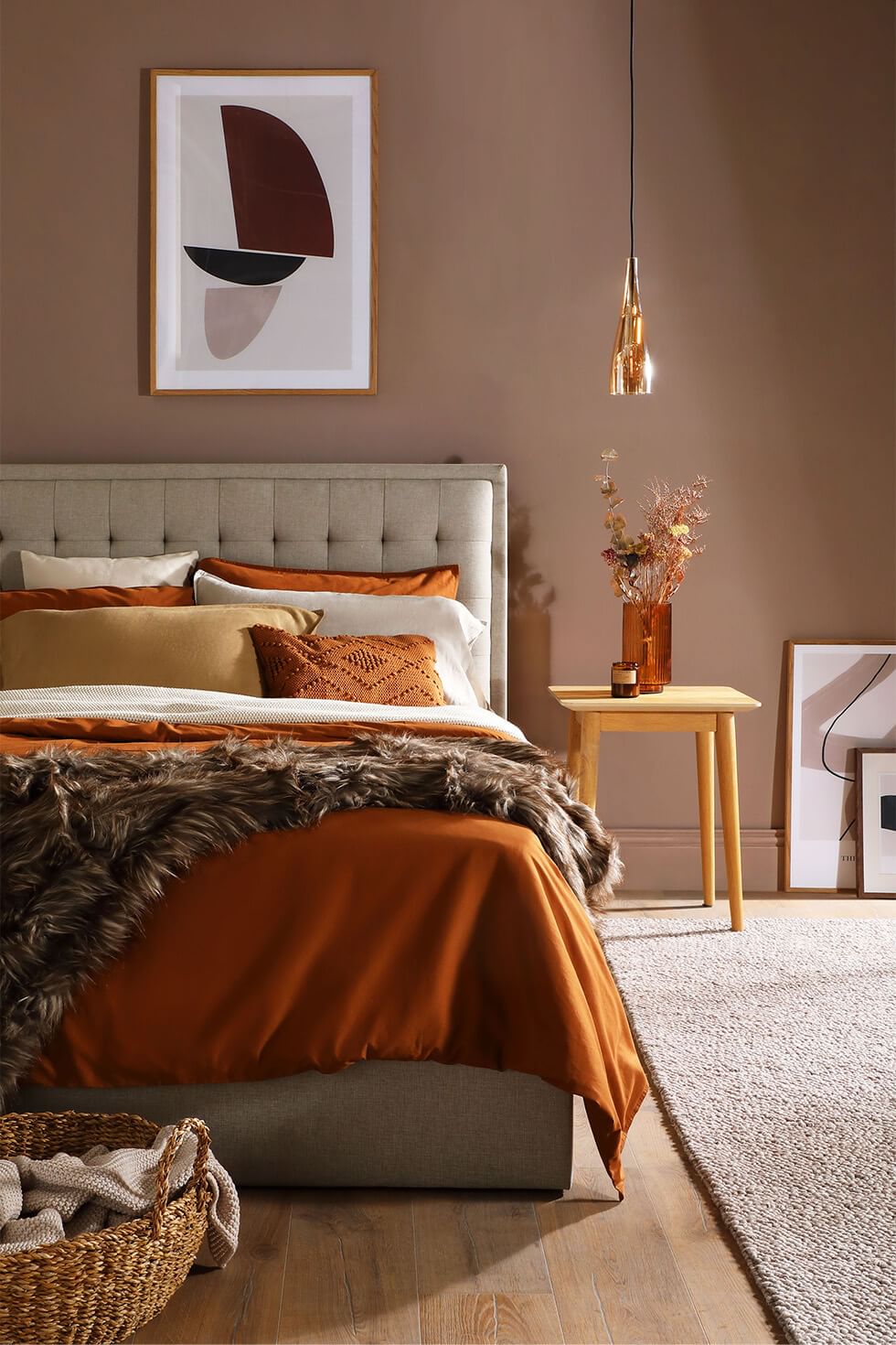 Comfy bed with multiple pillows and a faux fur throw