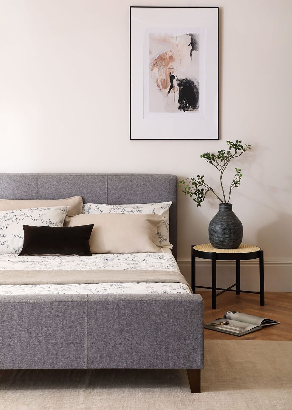 Minimalist bedroom with a grey upholstered bed frame