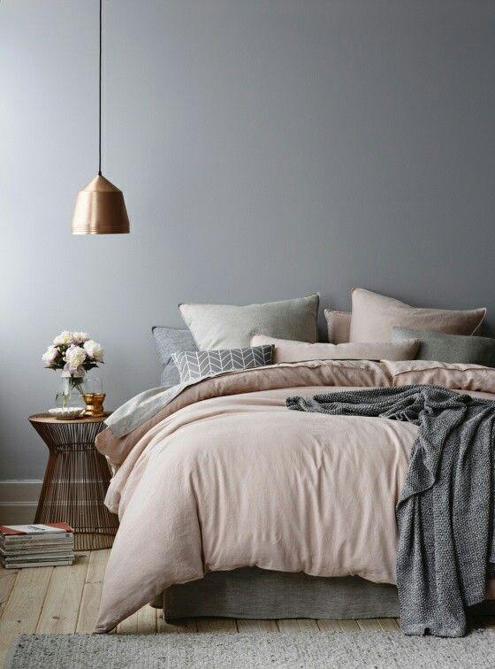 Grey and pink bedroom with a brass lamp