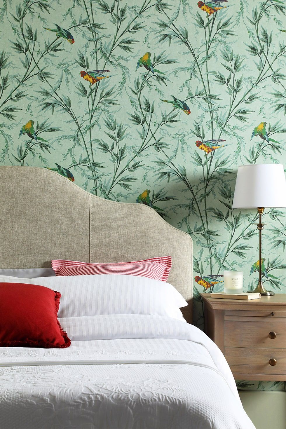 Classic fabric bed with botanical print wallpaper in the bedroom