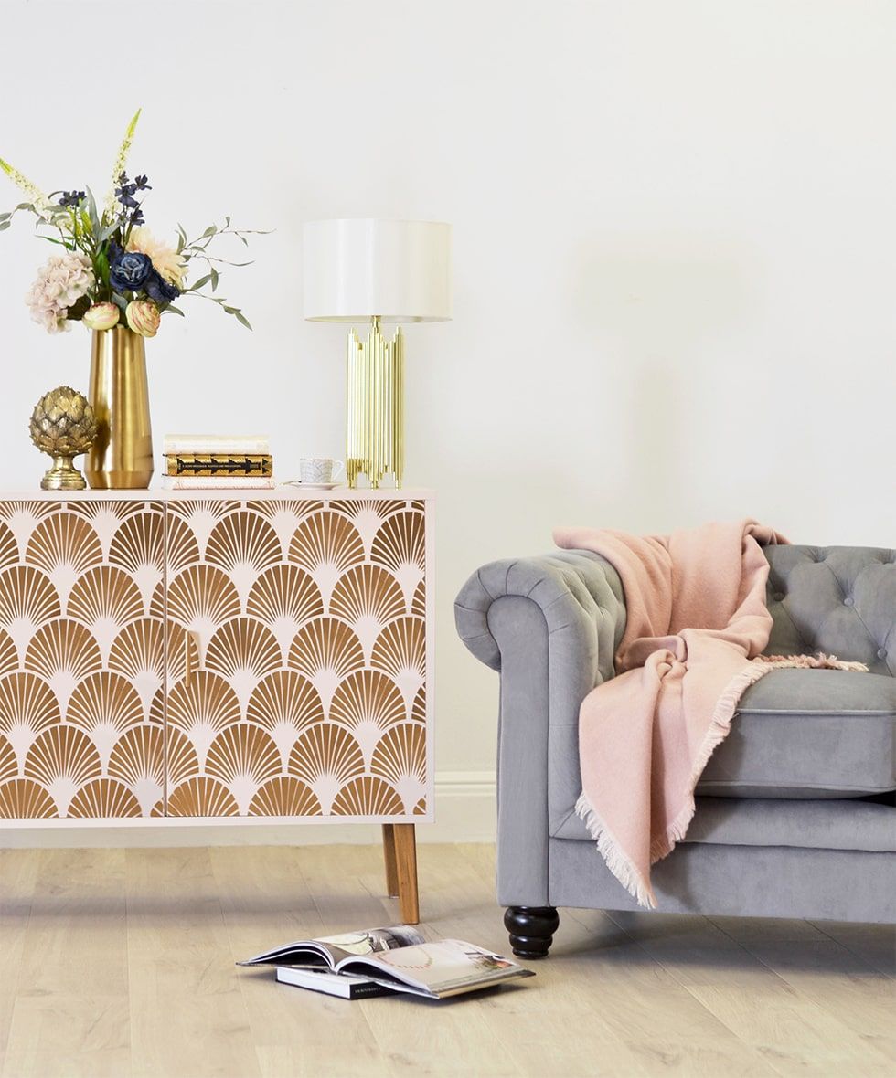 Art deco sideboard with a grey chesterfield sofa in the living room