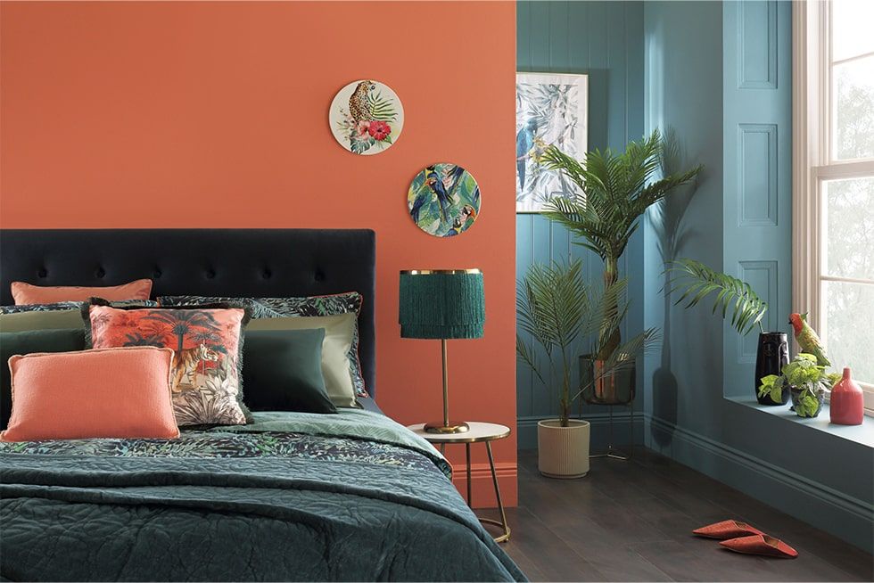 Bedroom with maximalist botanical prints and bright colour schemes