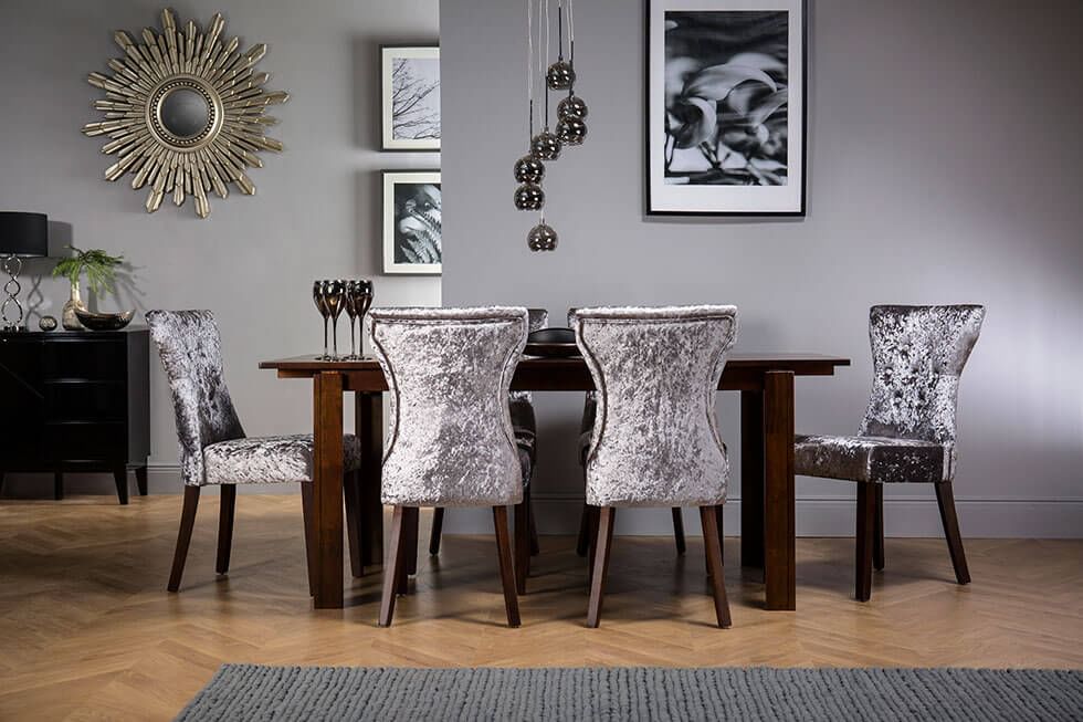Velvet dining chairs paired with a dark wooden table