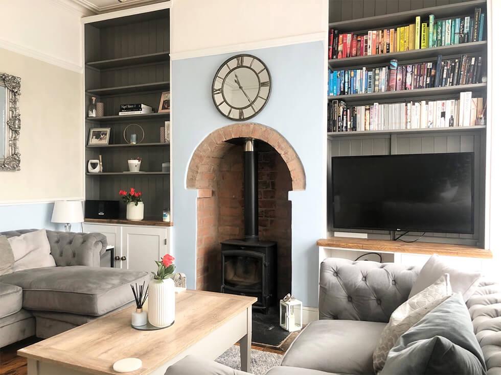 Living room with blue walls and traditional fireplace