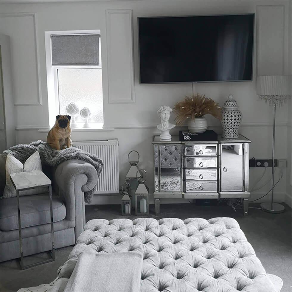 Grey living room featuring a mirrored sideboard