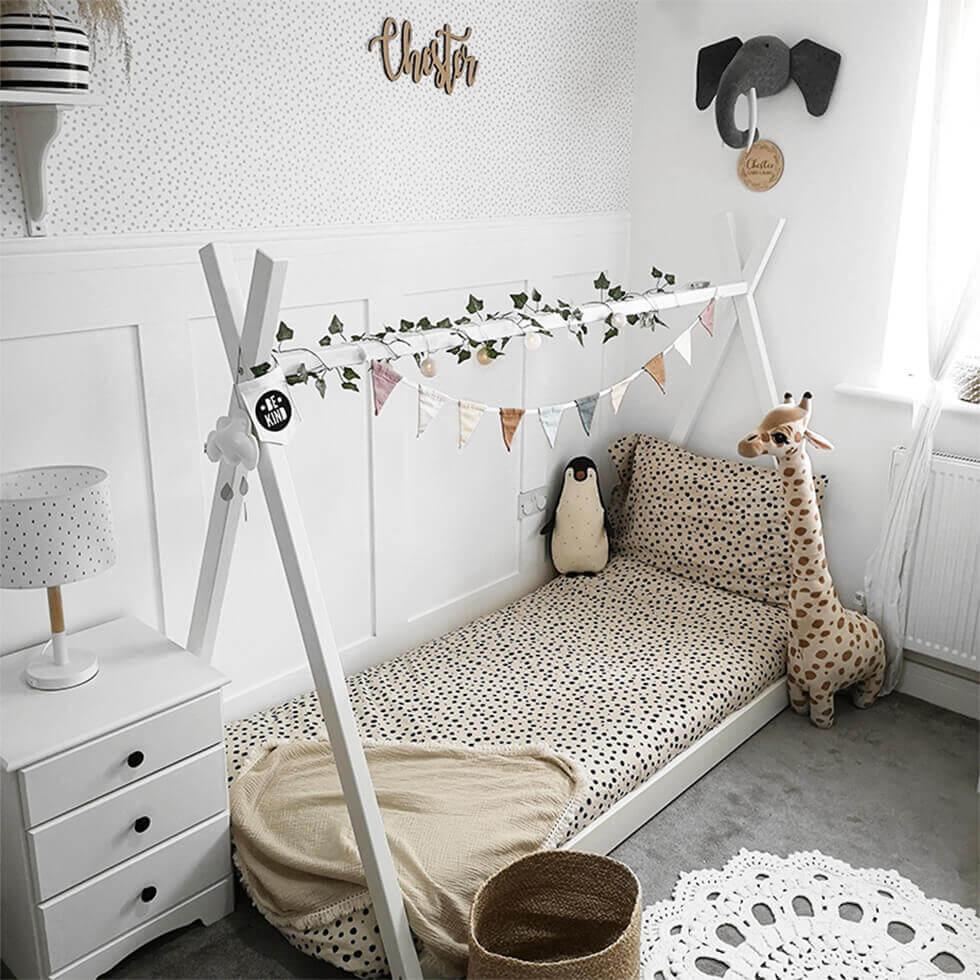 Playful children's bedroom with stuffed toys and animal print