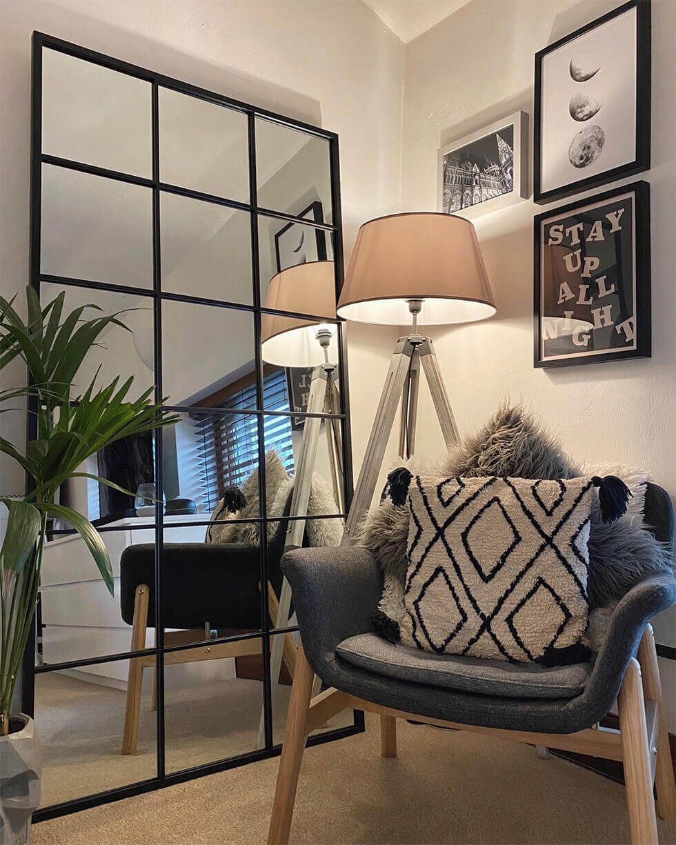 Living room corner with a full-length mirror and gallery wall