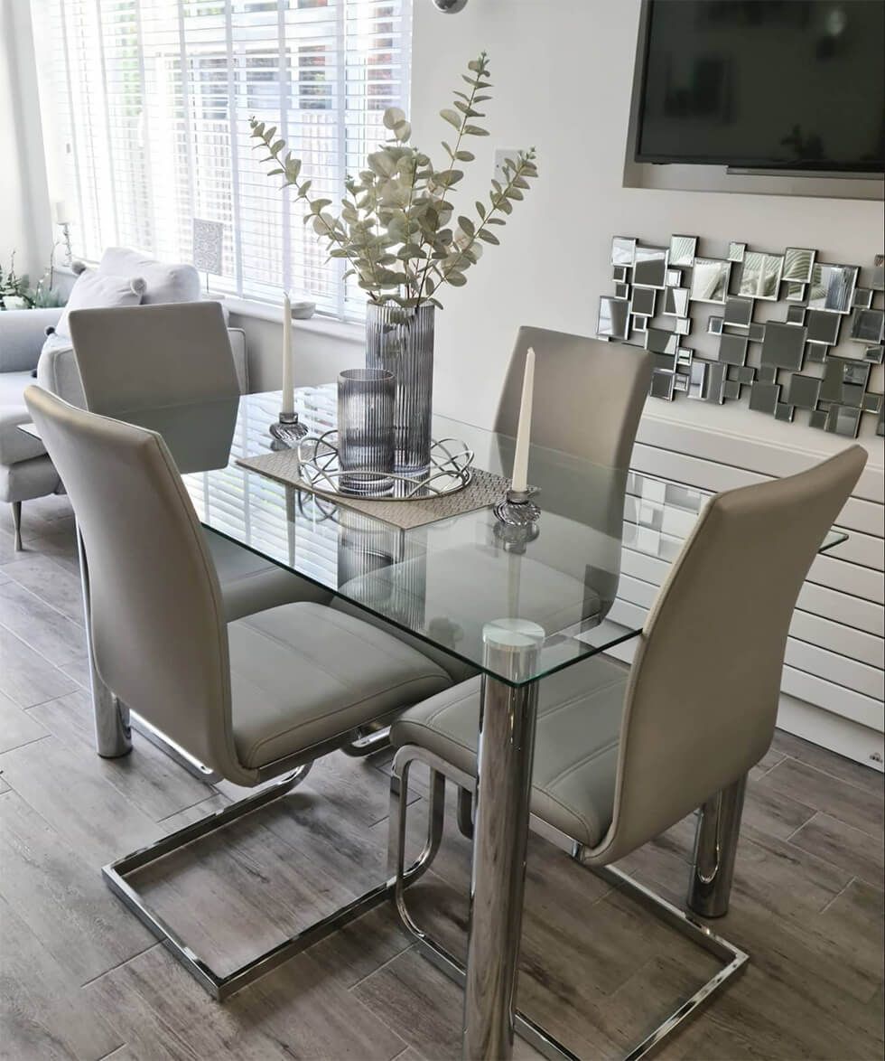 Glass and chrome dining table with grey velvet chrome chairs