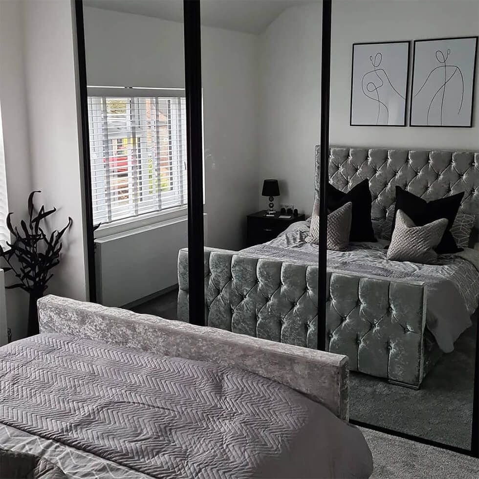 Neutral bedroom with grey velvet bed and mirrored wardrobe