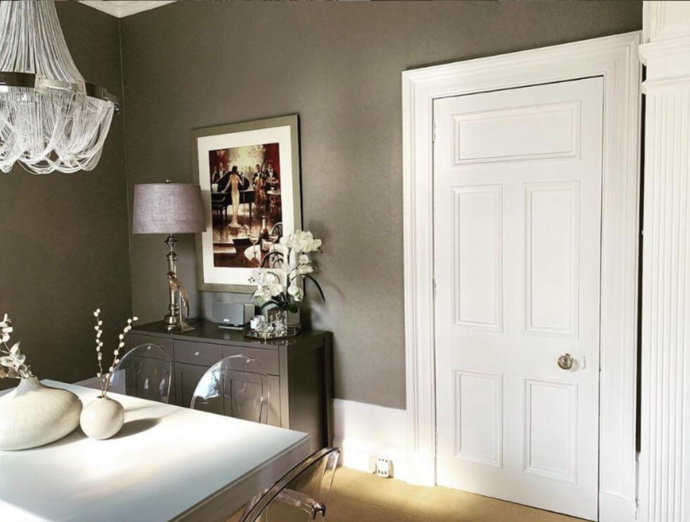 Side shot of dining room with sideboard and white dining table