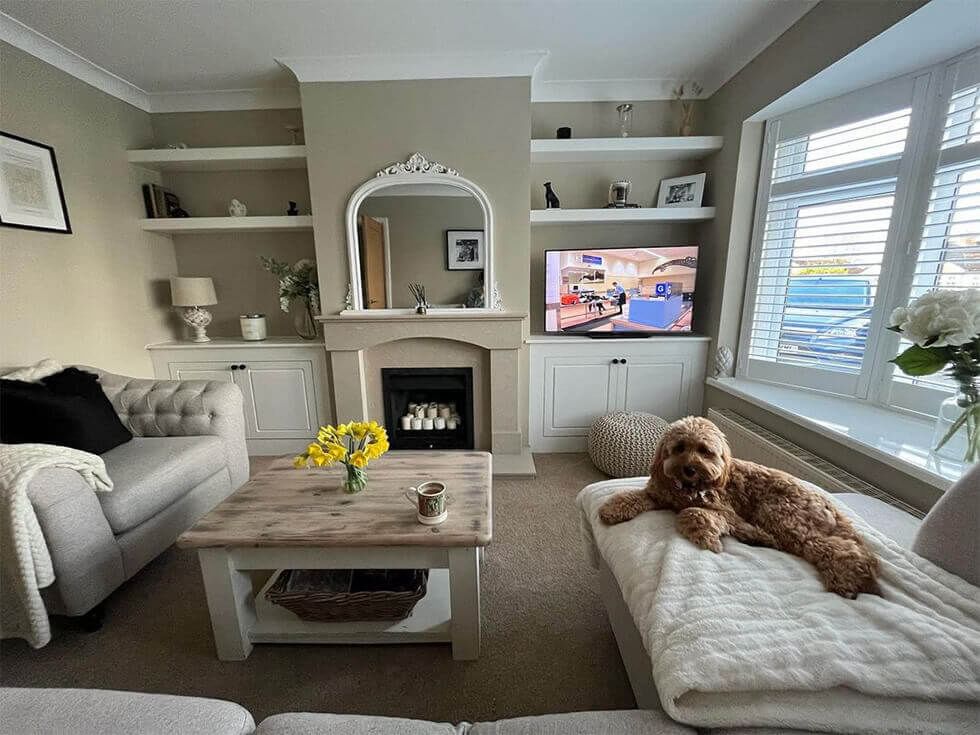 Relaxing front lounge with a cosy fireplace and alcove