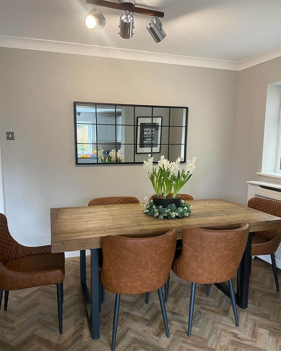 Industrial style dining area with wooden dining table and chic leather dining chairs