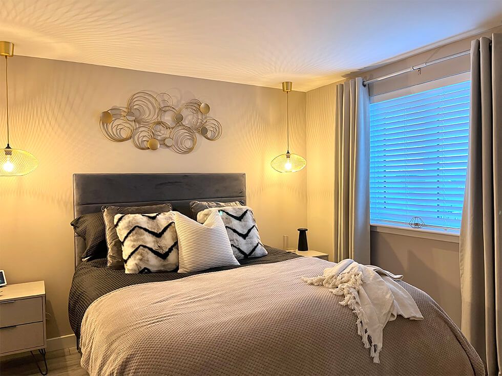 Cosy neutral bedroom with cushions and throws