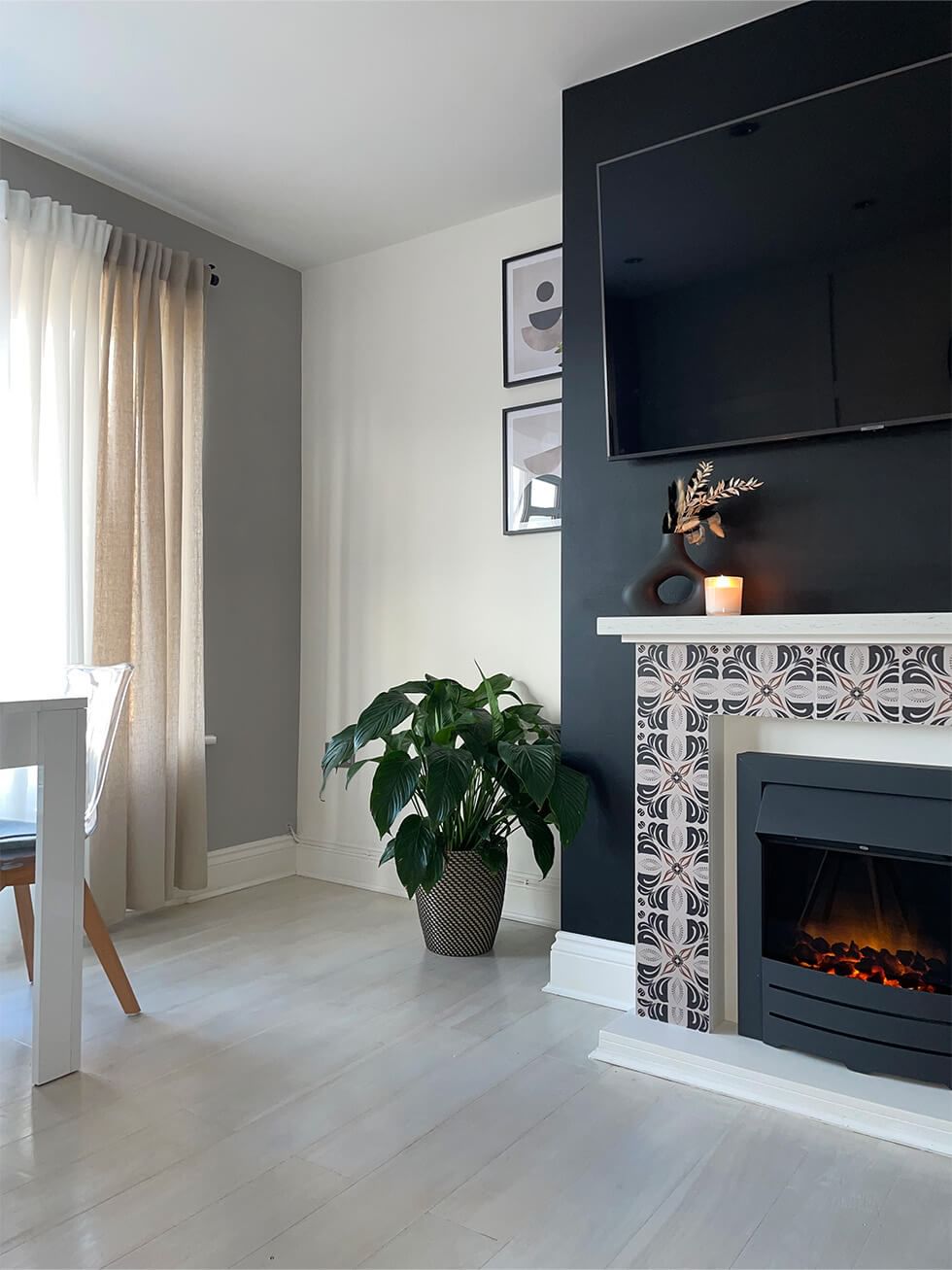 Black TV wall and patterned fireplace in living room